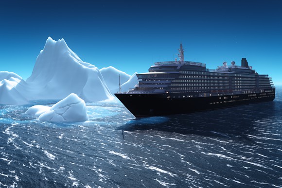 Cruise liner sailing past icebergs