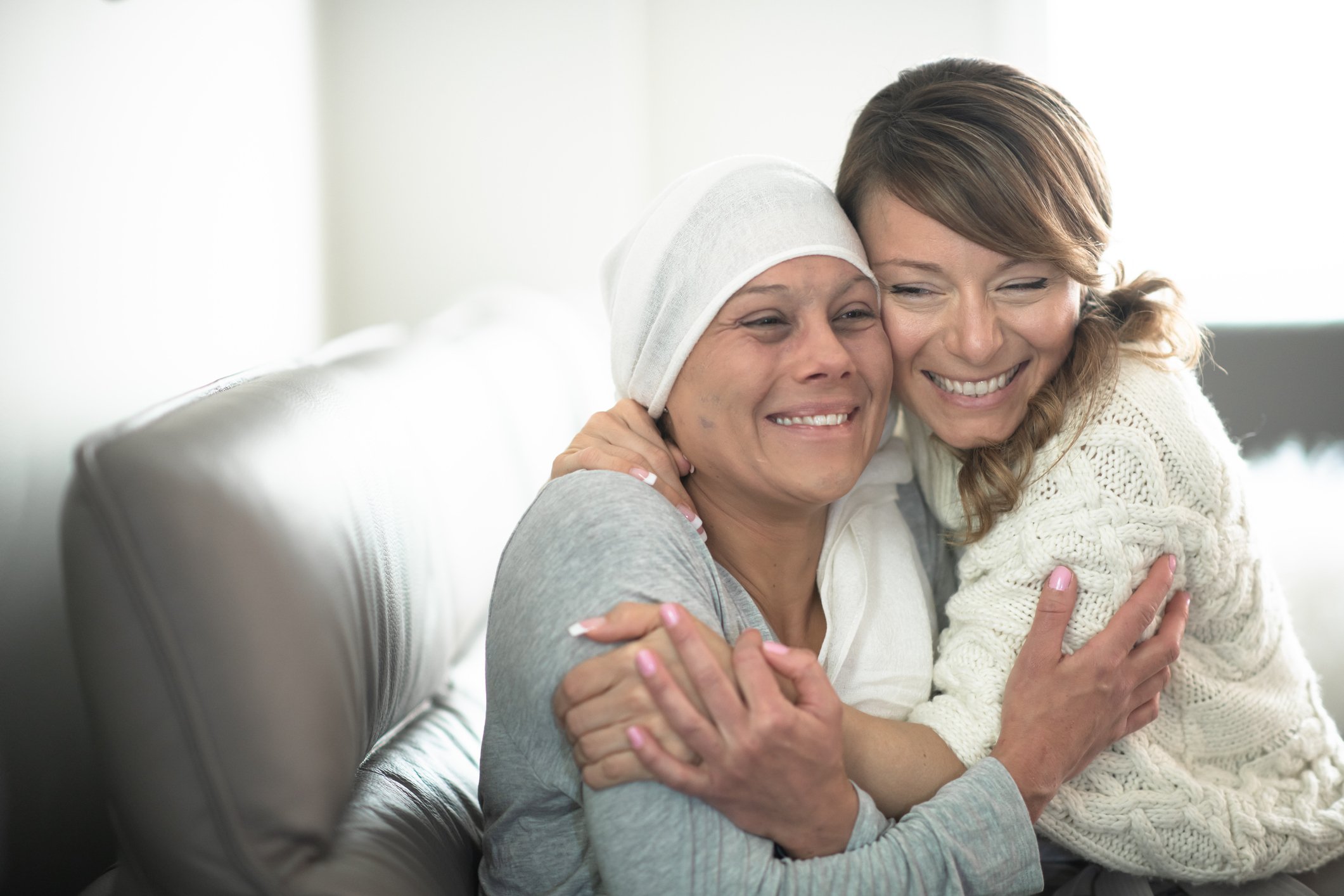 A person hugging a cancer patient.