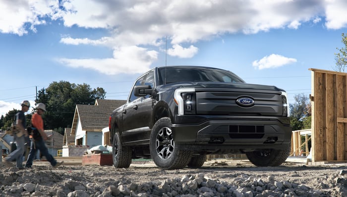 A Ford F-150 Lightning Pro, an electric pickup designed for commercial fleets, shown on a construction site. 