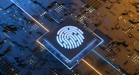 Computer chip emblazoned with a glowing fingerprint.