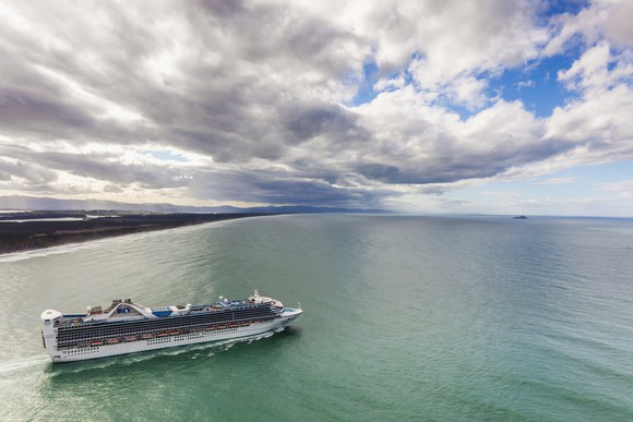 A cruise ship sailing away from shore.