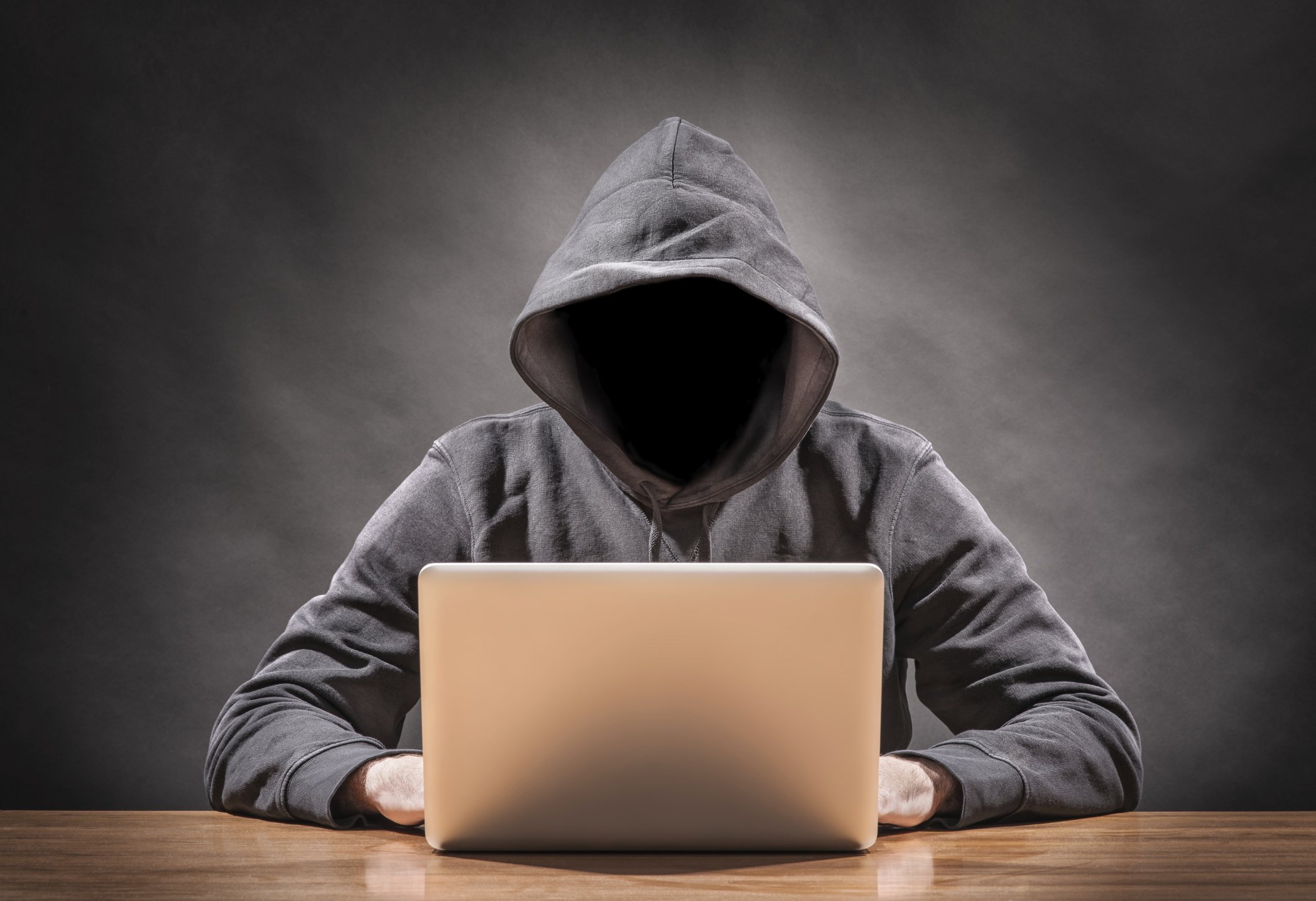 hacker in hoodie identity theft cyber security