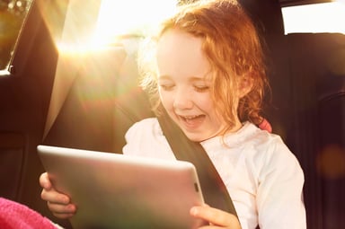 A child looking at a tablet.