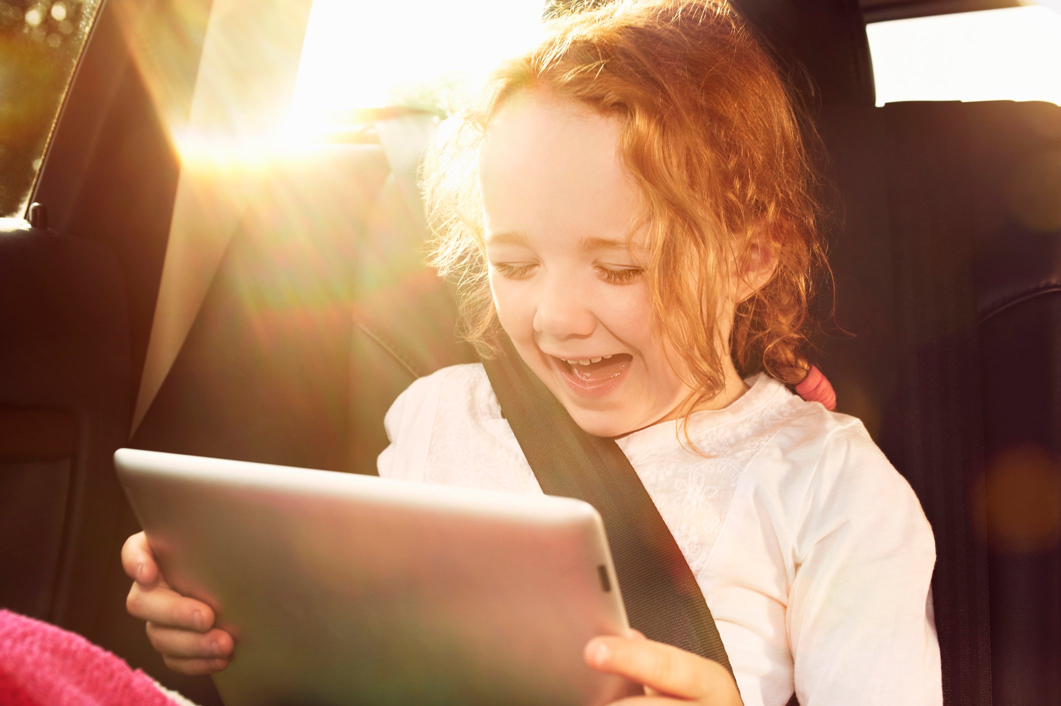 A child looking at a tablet.