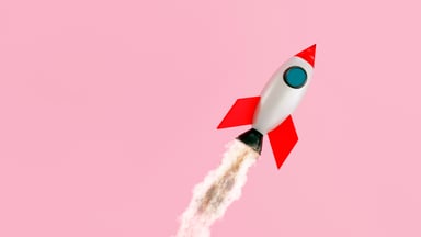 A toy rocket ship flies through the air.