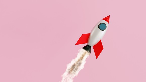 A toy rocket ship flies through the air.