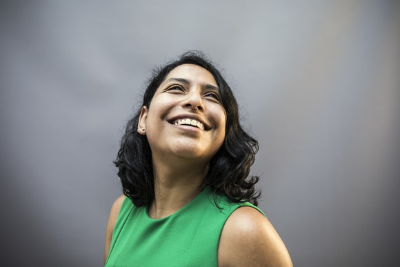 happy person smiling against gray background