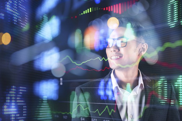 Person looking at stock charts.