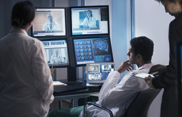 Multiple physicians communicating with telemedicine platform.