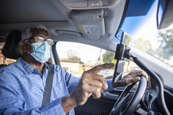 Man setting up navigation in car.