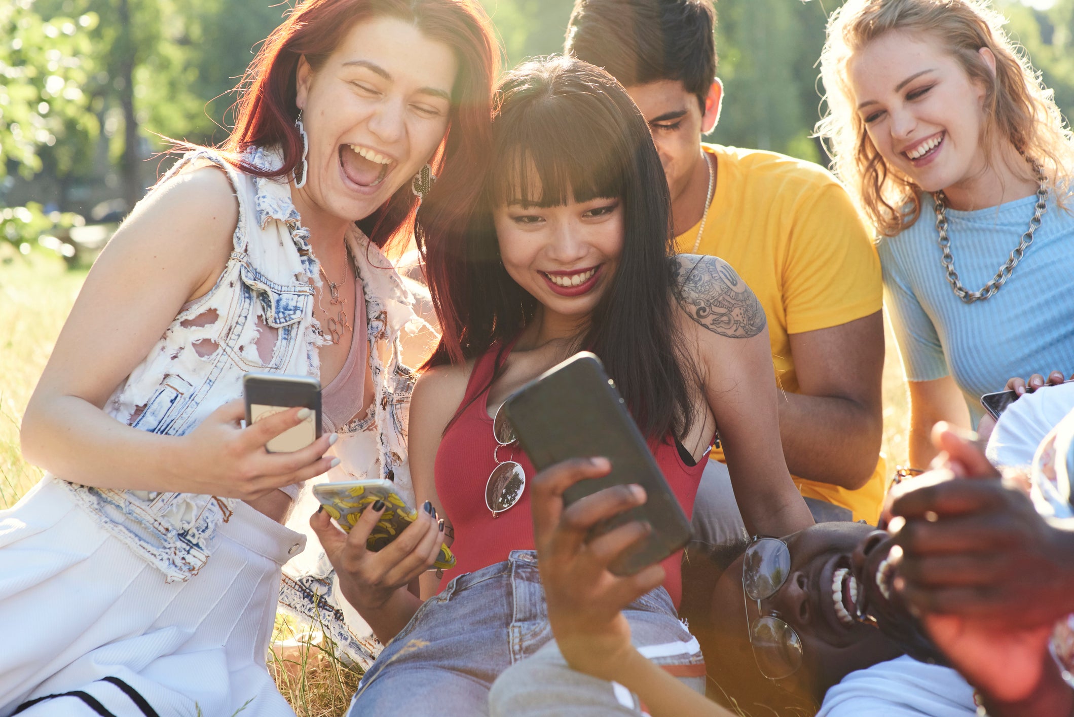 Five people looking at mobile devices.