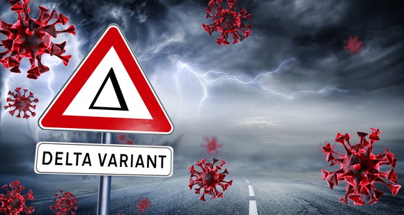 Delta variant sign with images of coronavirus virions and dark clouds with lightning in the background.