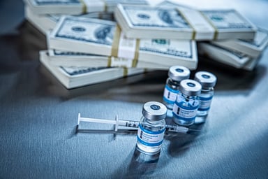 Vaccine vials with multiple stacks of cash