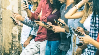 GettyImages line of people on their smartphones