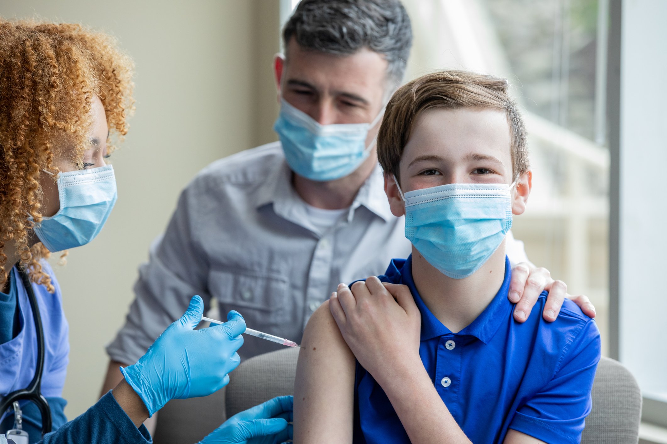 Young person receiving vaccine shot.