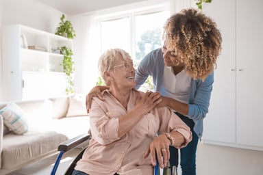 Nurse taking care of someone in a wheelchair.
