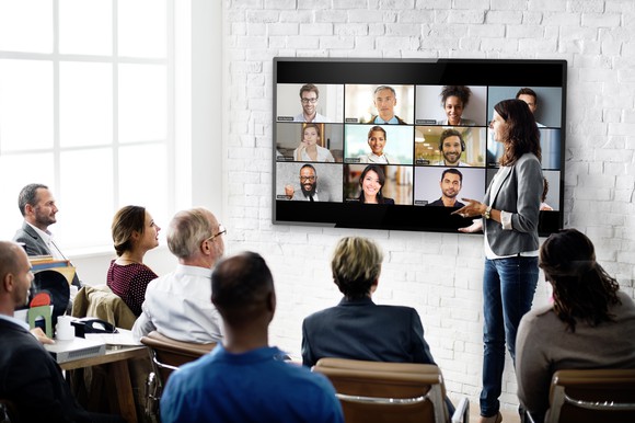 A group of employees attend a Zoom meeting.