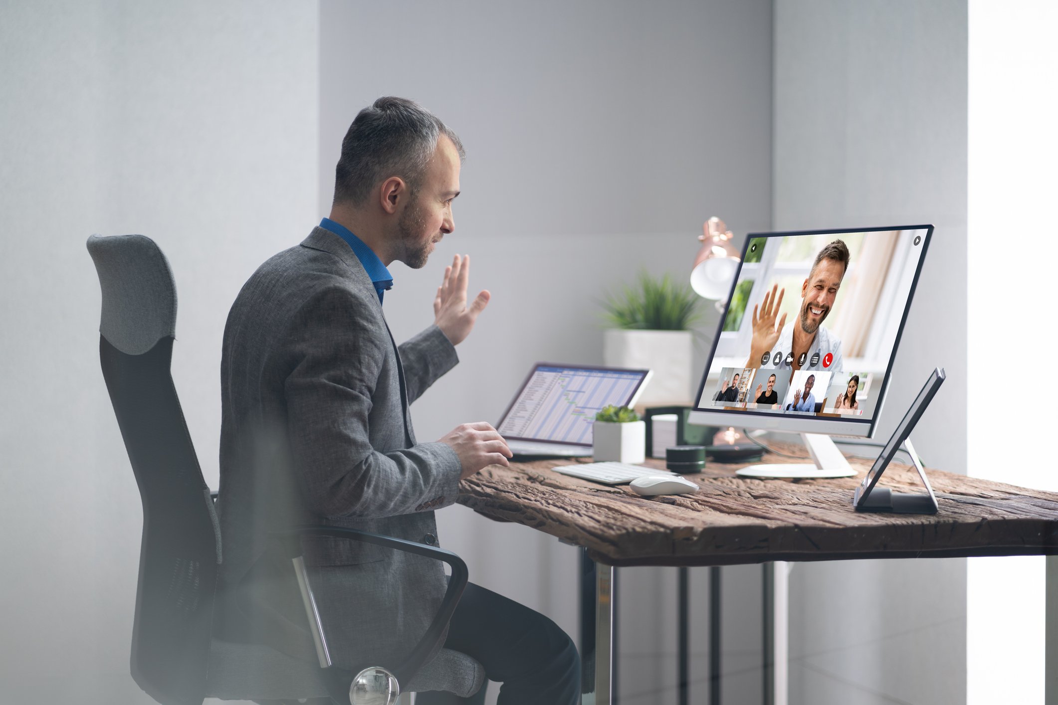 A businessperson using a webcam during a virtual meeting.