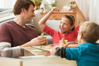 a father playing board games with children
