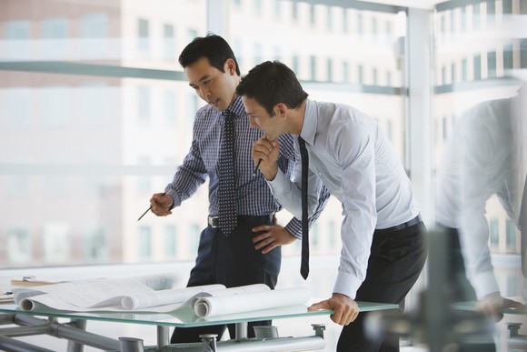 Two people looking intensely at documents.