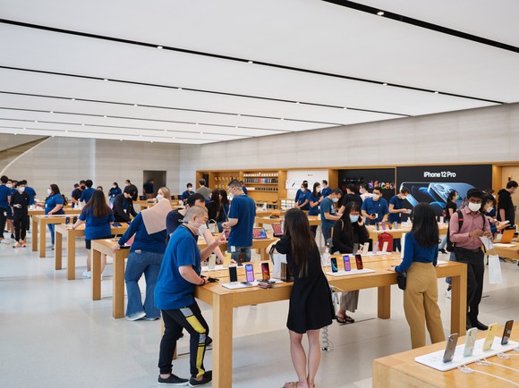 Customers browsing inside an Apple retail store.