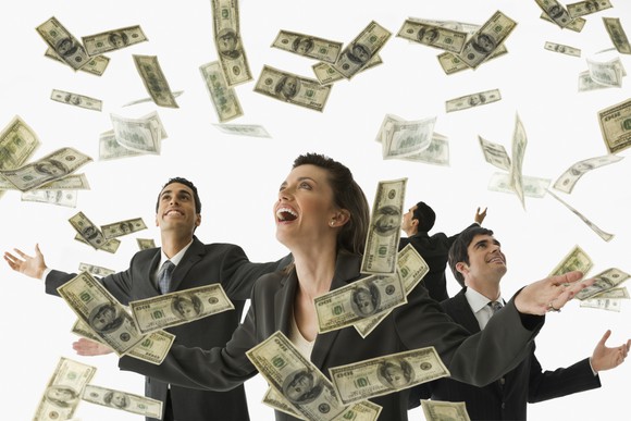 A group of people happy that cash is falling from the sky. 