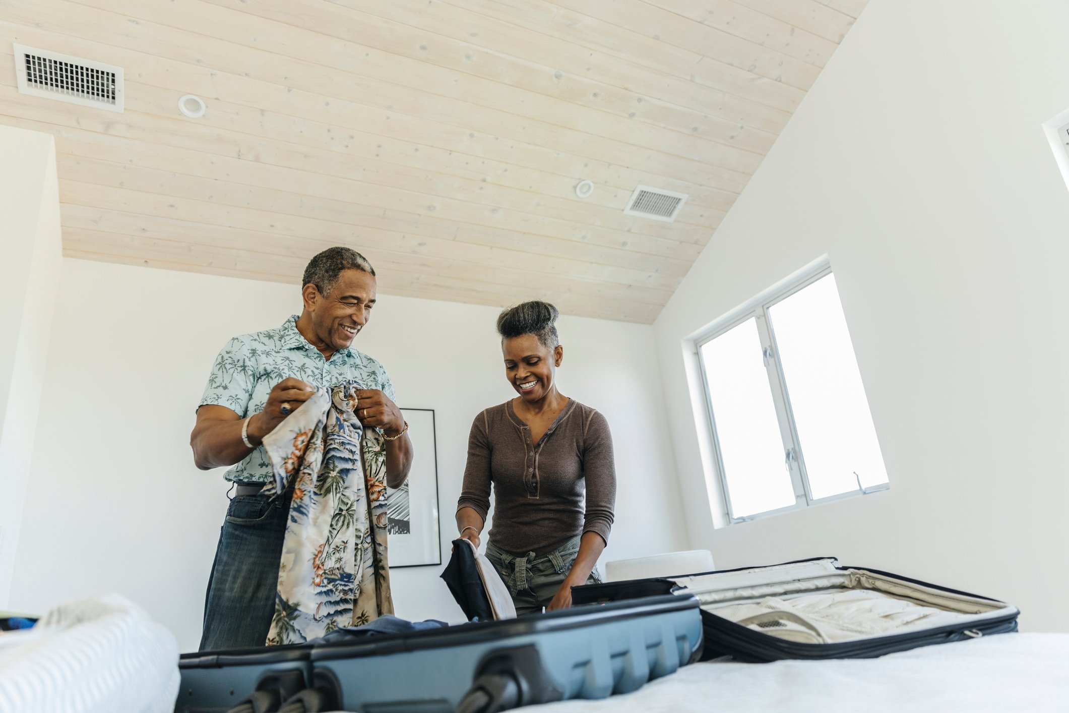 A man and woman unpacking a luggage.