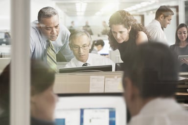 People crowding around a computer.