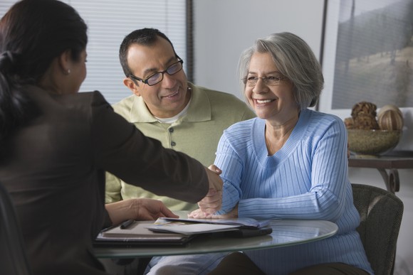 Two people meeting with a financial advisor.