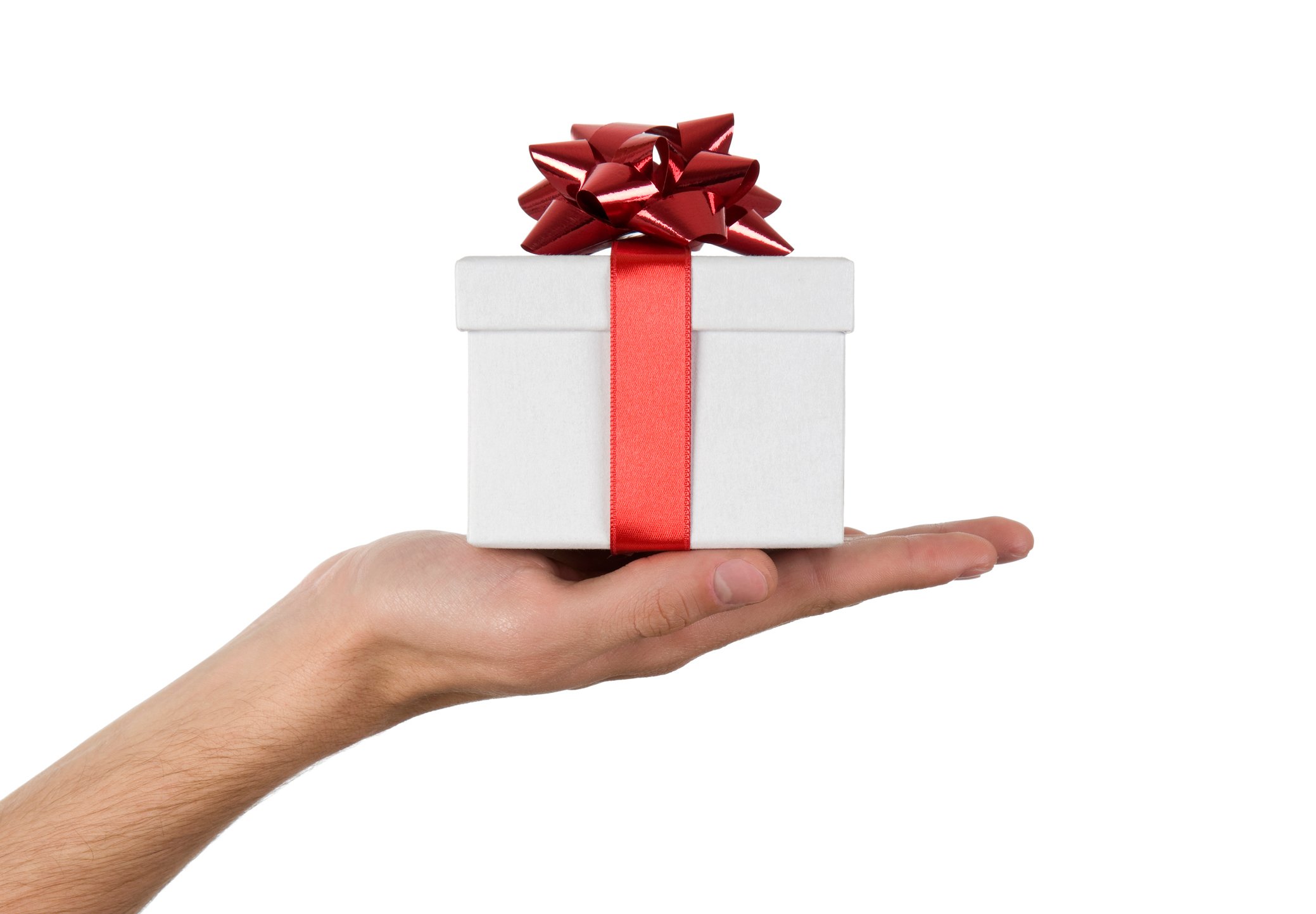 An outstretched hand holding a white box with a red bow tied around it. 