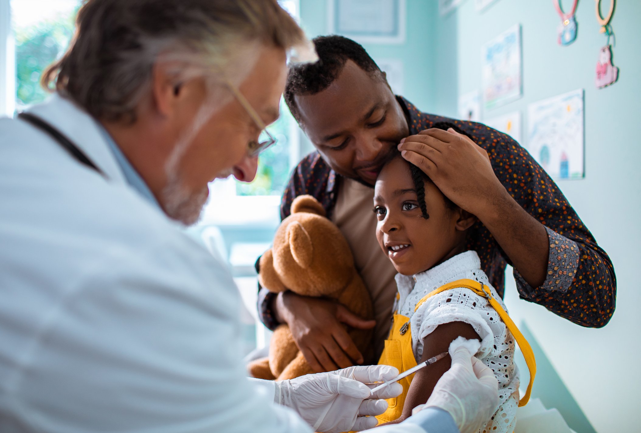 Doctor putting a needle in a patient.