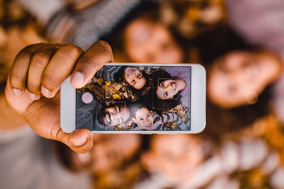 A group of people taking a selfie together.