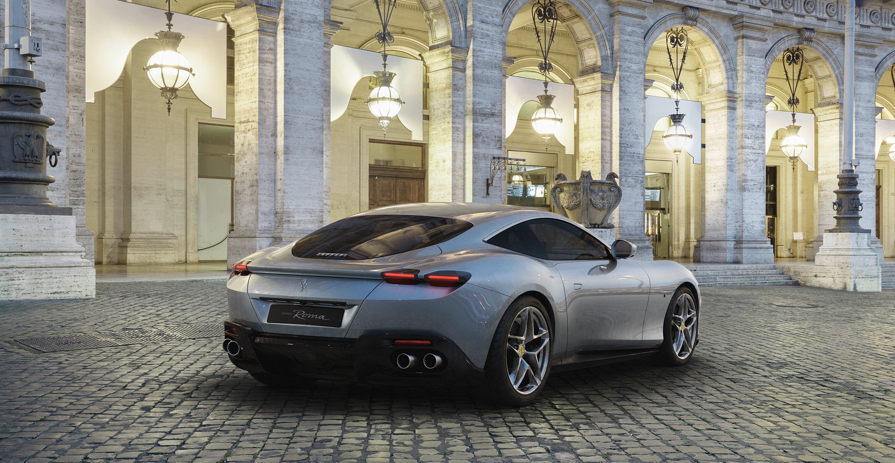 A silver Ferrari Roma, a sleek front-engined grand touring car. 