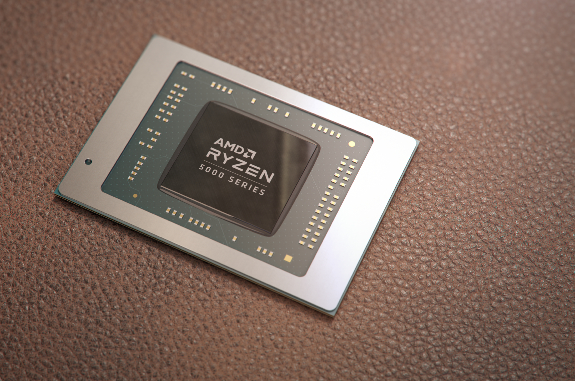 The AMD Ryzen 5000 processor chip is shown sitting on a pebbled surface