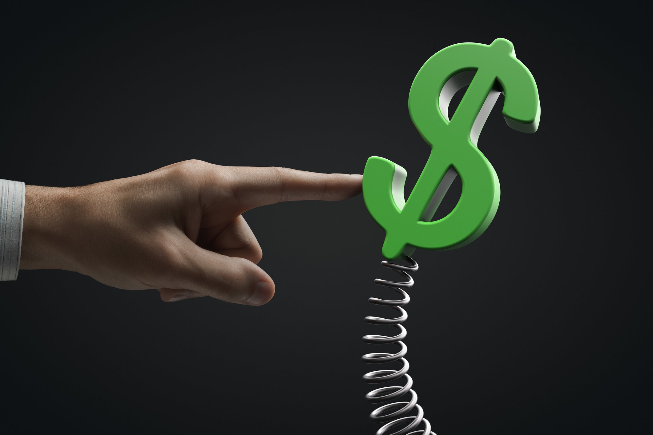 A dollar sign on a spring being pushed by a finger.