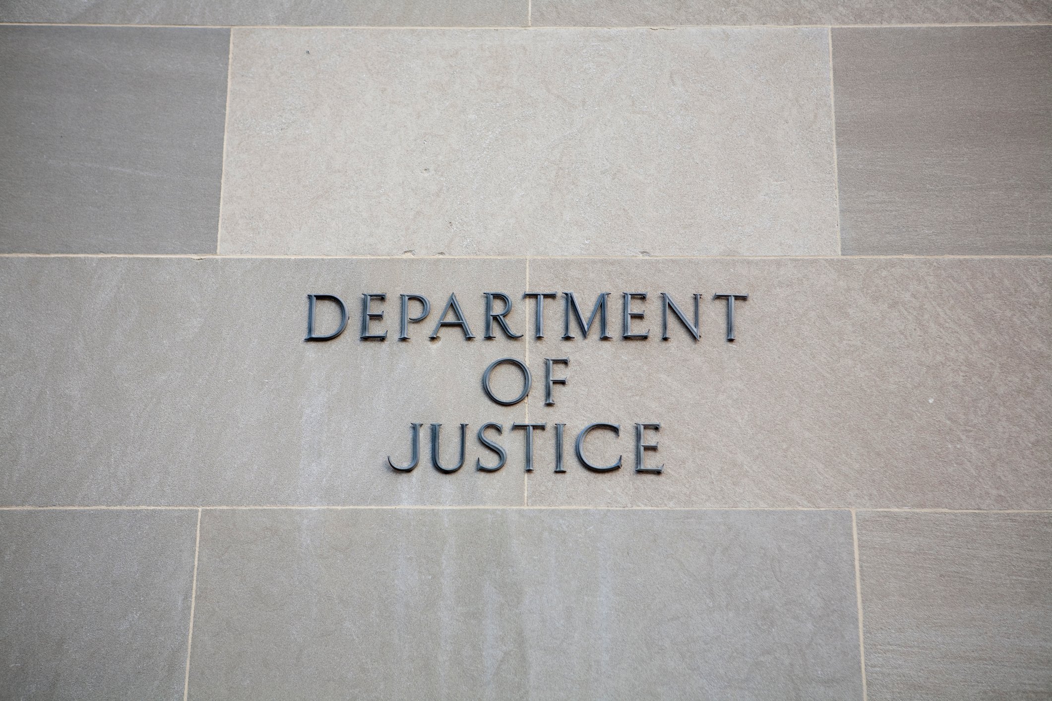 A sign showing the words "Department of Justice".