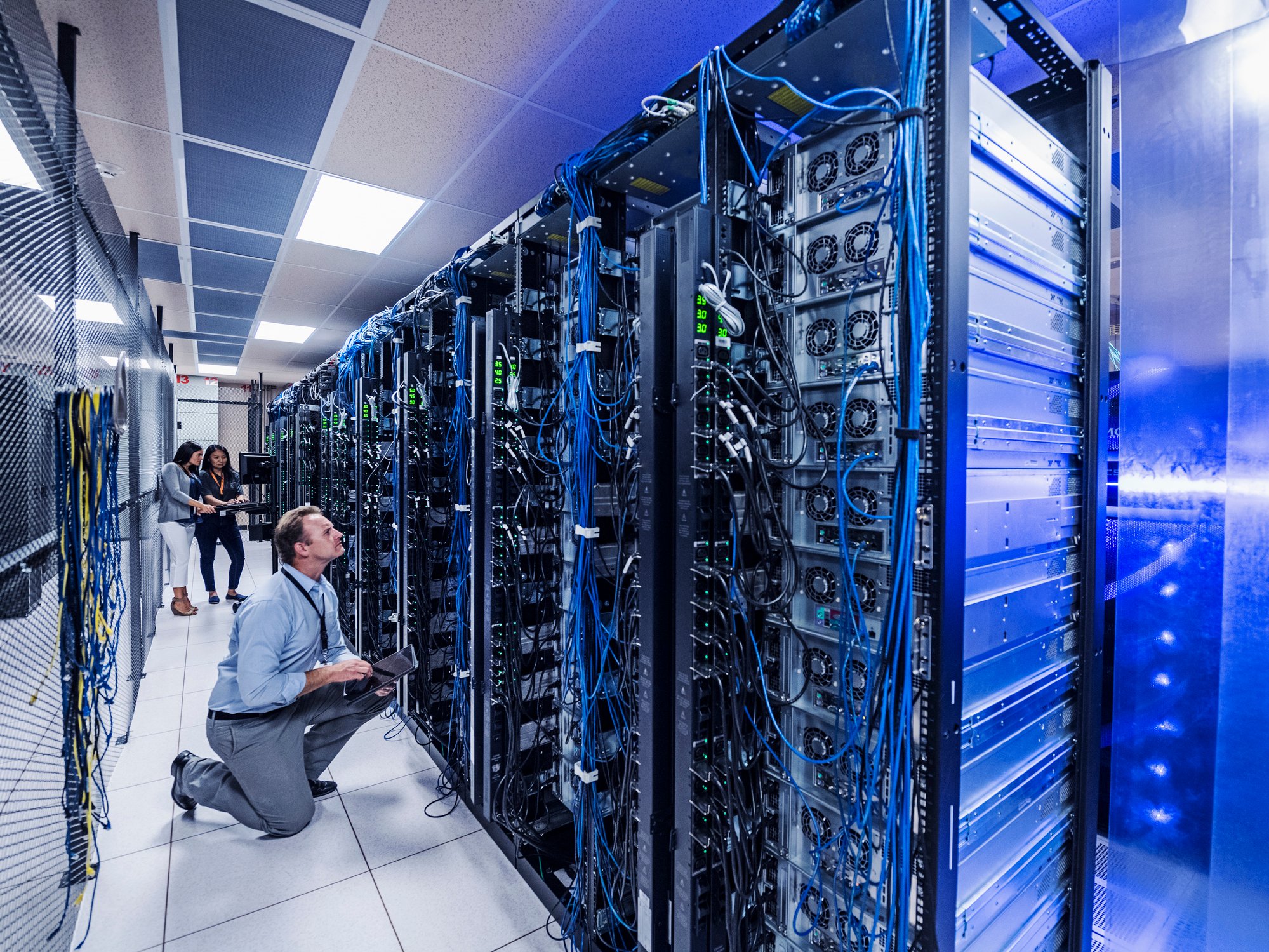 Workers in computer server room.