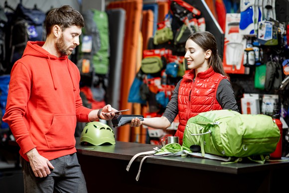 A person paying for some items at a sporting goods store.