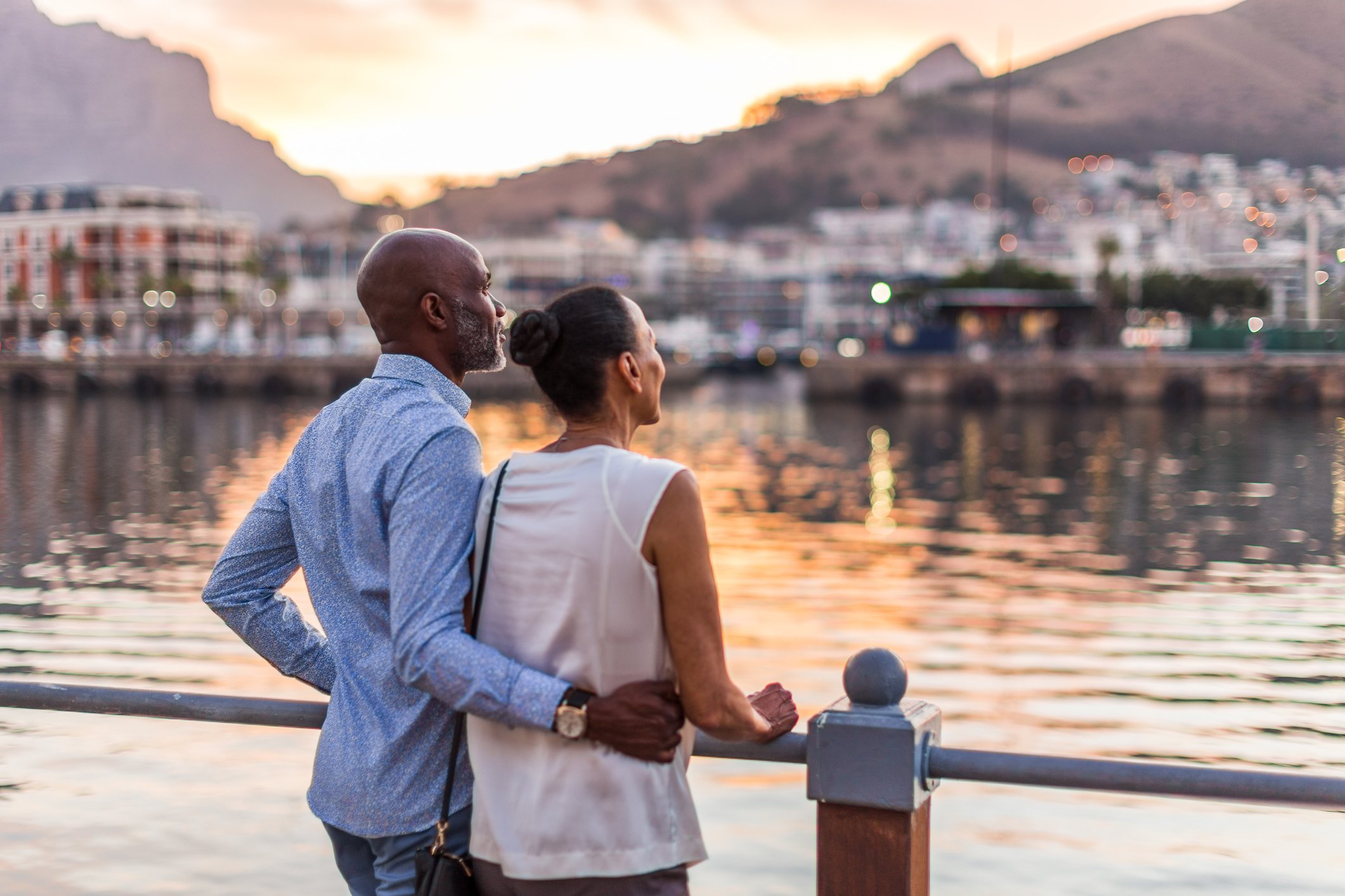 A couple looking out over a waterway on vacation.