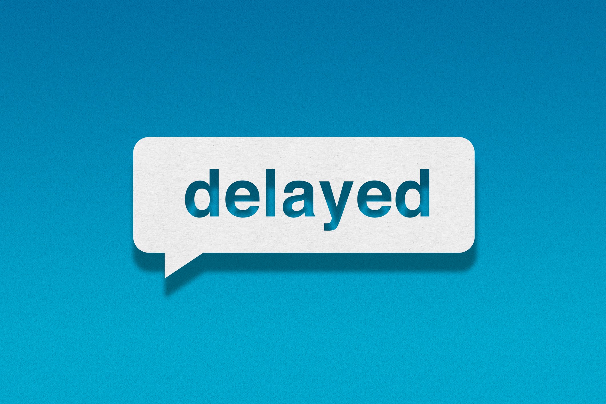 Speech bubble containing the word "delayed" with a blue background.