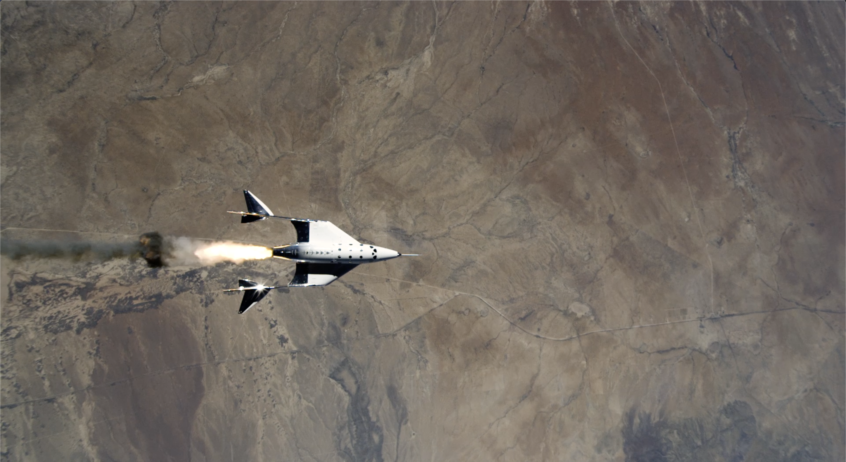 Virgin Galactic spaceplane igniting after drop from mothership.
