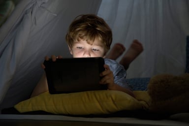 Kid using tablet in the dark
