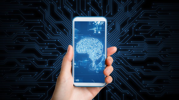 Closeup of phone screen with picture  of a human brain on it. 