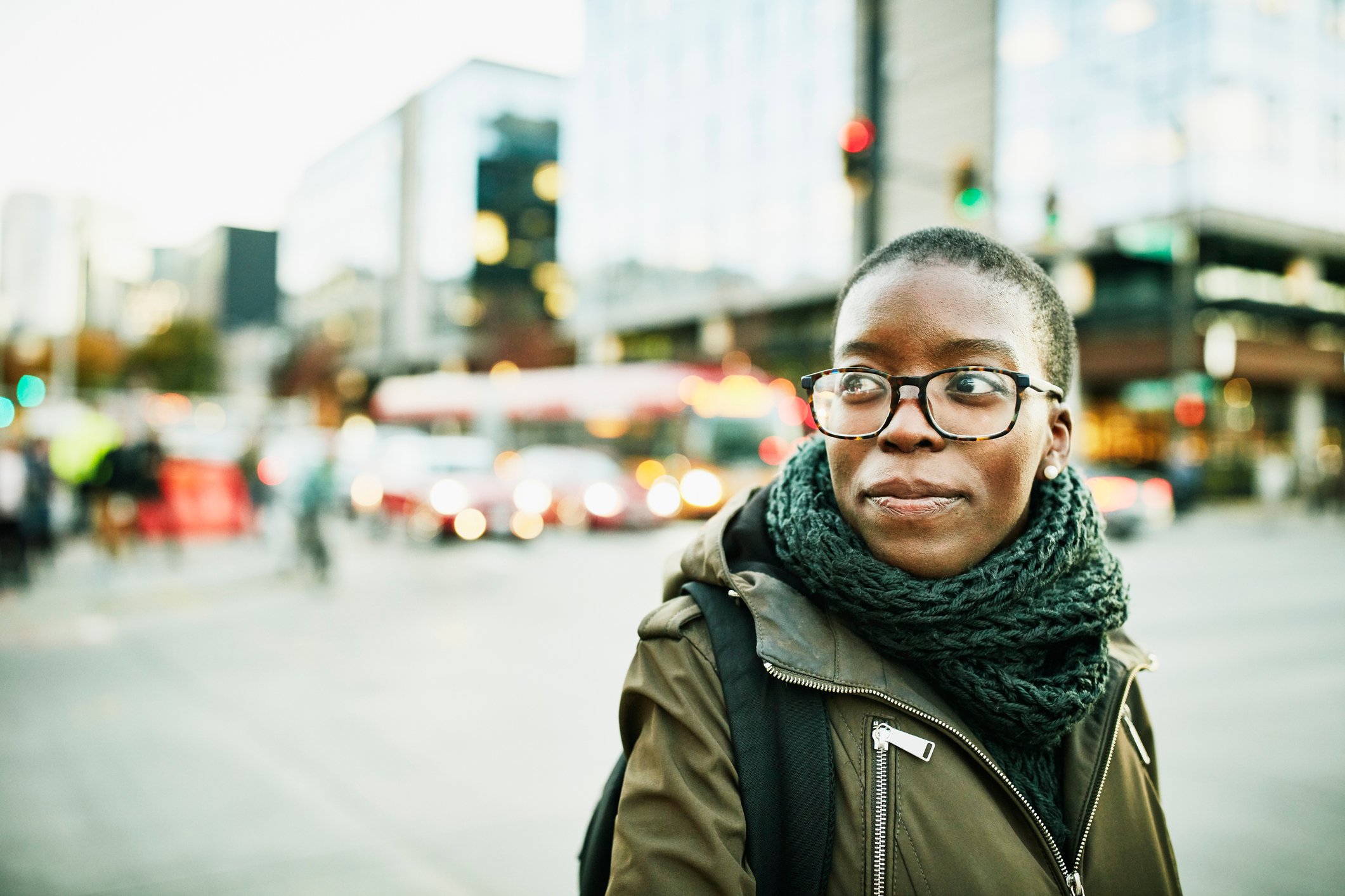 Close-up of smiling adult walking on the street in the city.