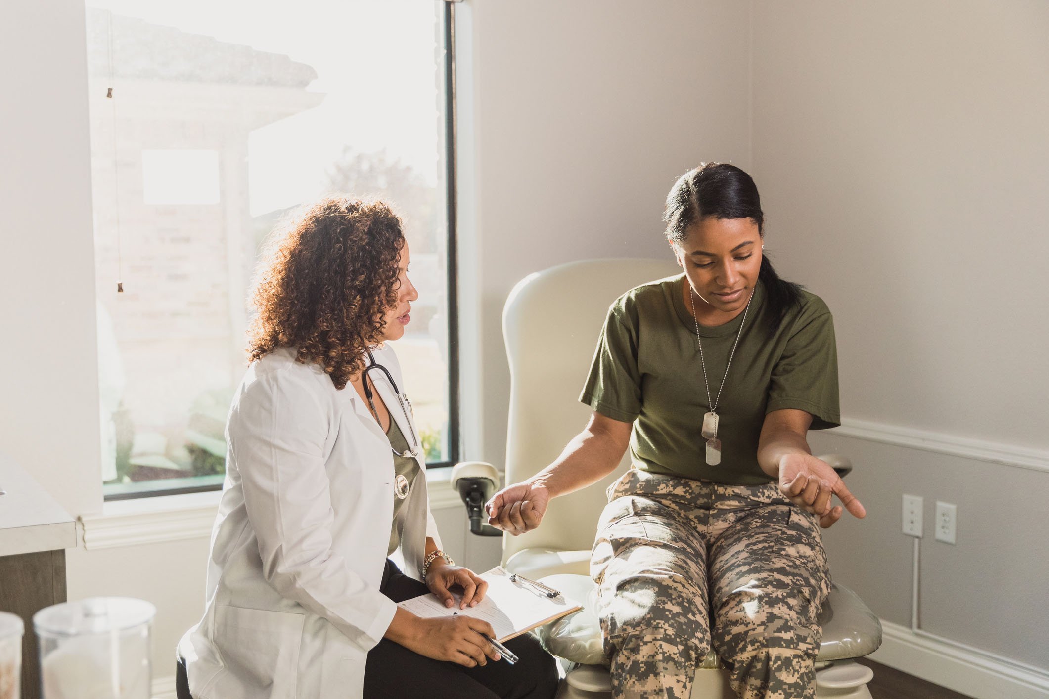 Patient and a dermatologist in a doctor's office.