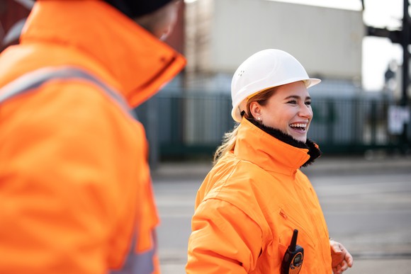 A person in a hardhat at a port.