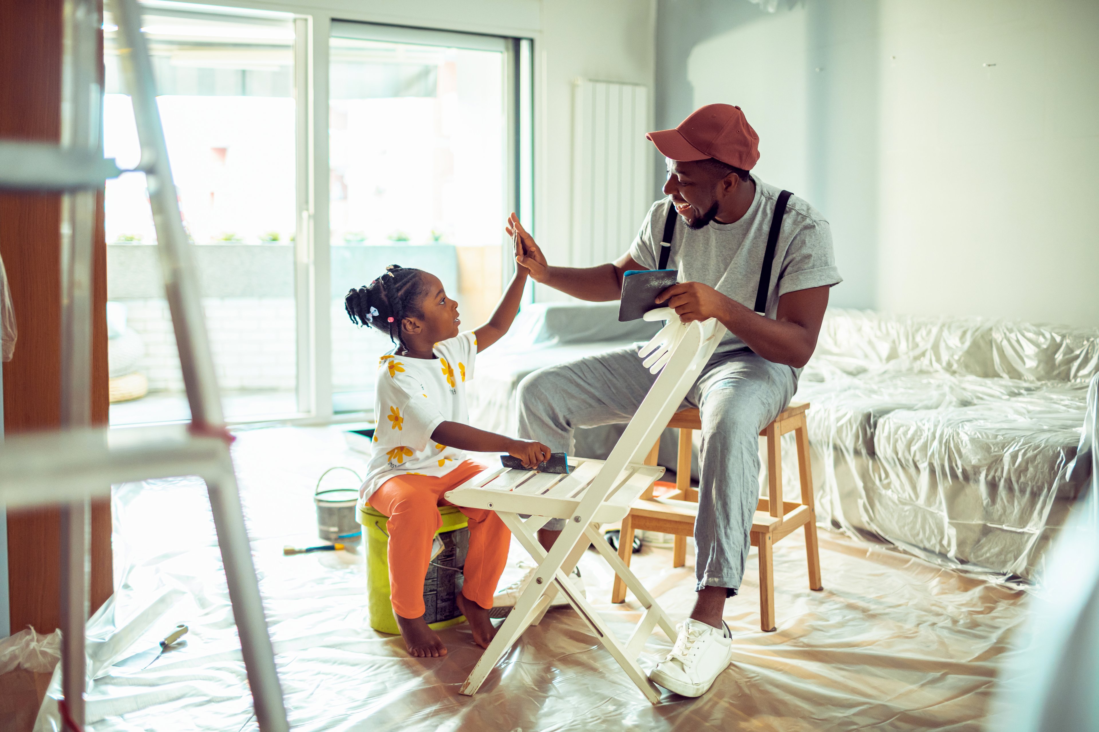 Father and daughter working on a home improvement project. 