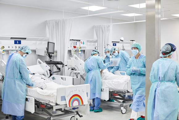 Medical professionals working in an intensive care unit.