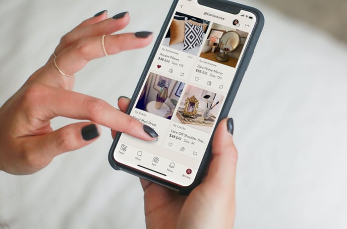 A woman viewing Poshmark's mobile site on an Apple iPhone. 