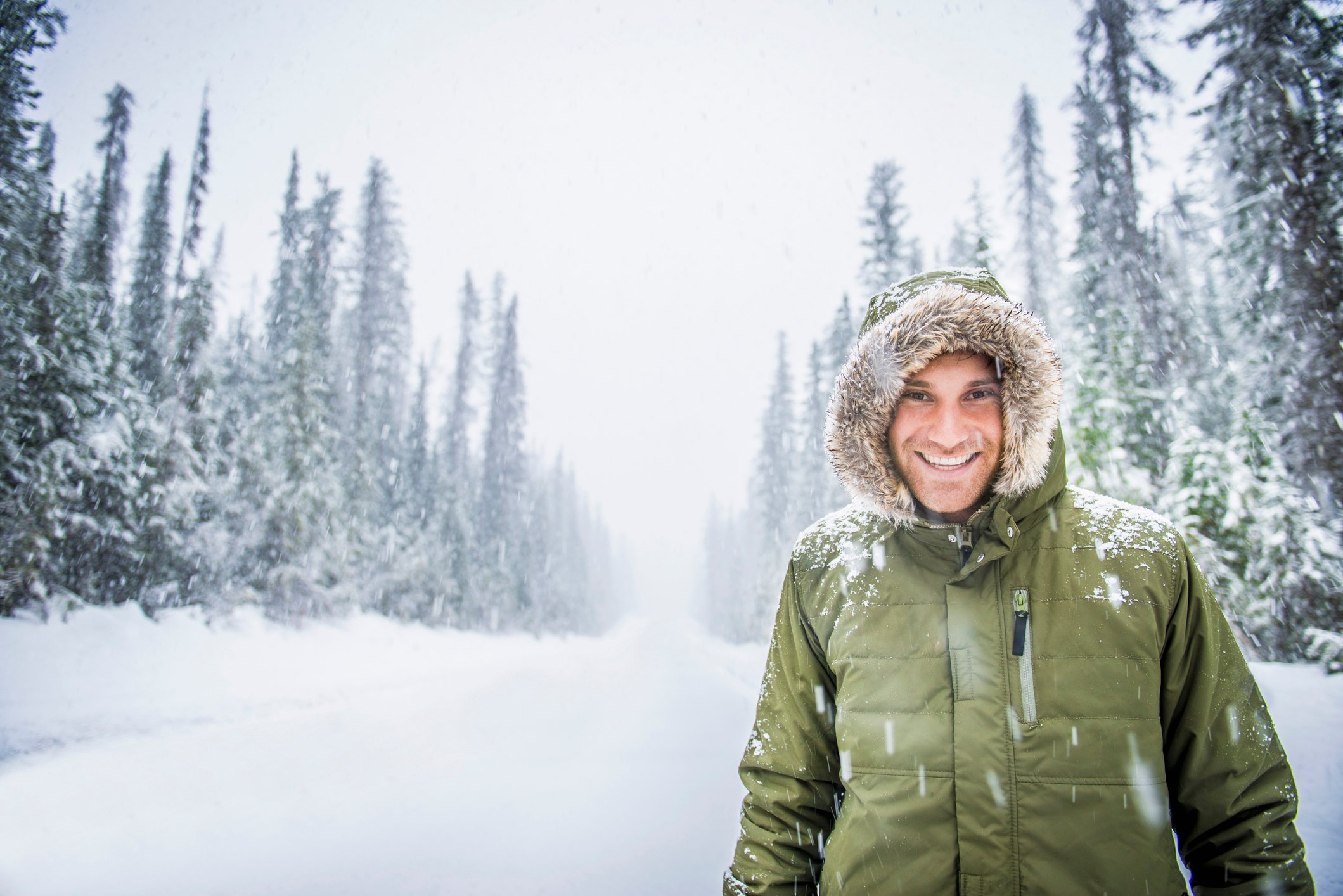 A person wearing a down coat in a snowy landscape.